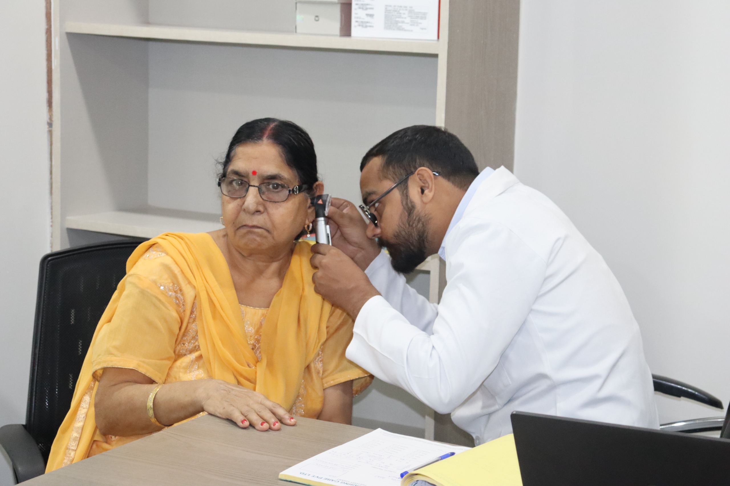 Ajay looking at patient ear