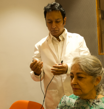 Audiologist getting ready to fit hearing aids on a customer